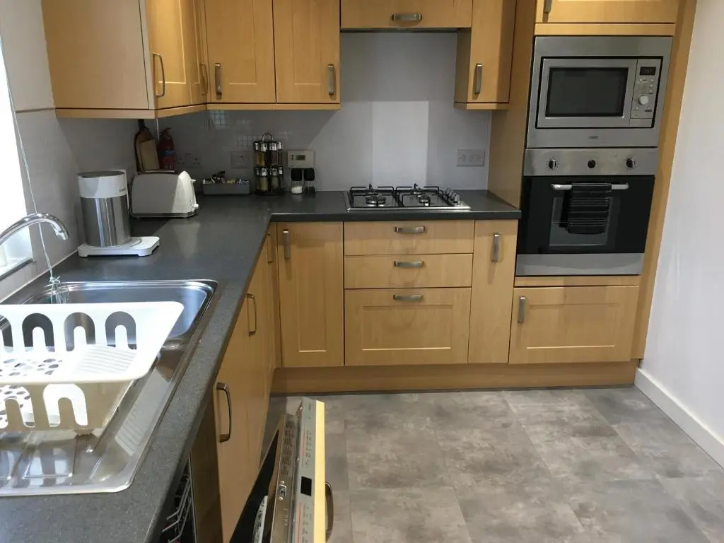 a kitchen with a sink and a stove top oven at Columba House in Inverness