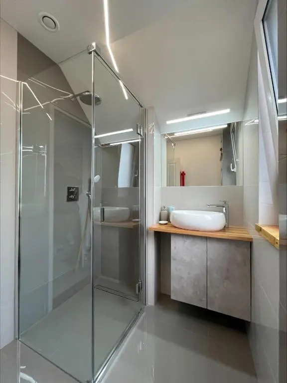 a bathroom with a glass shower and a sink at Columba House in Inverness