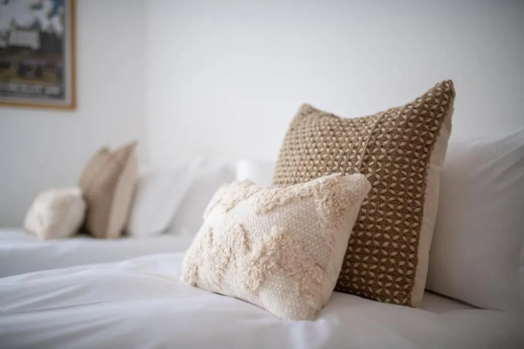 a group of pillows sitting on top of a bed at End House Inverness in Inverness