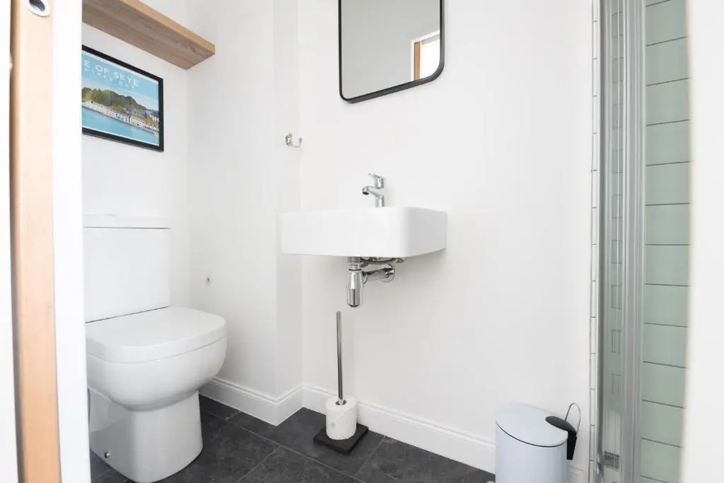a bathroom with a toilet and a sink at End House Inverness in Inverness