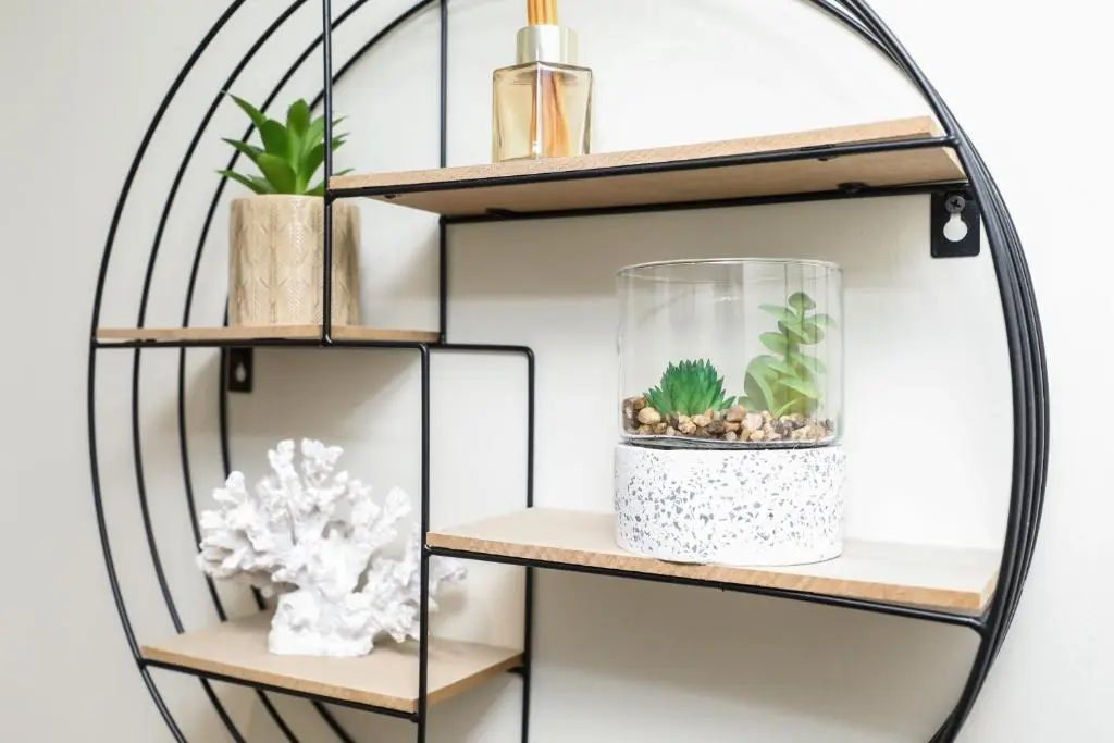 a black and white shelf with plants and a glass vase at mySTAYINN Tomnahurich 3 Bedroom House in Inverness