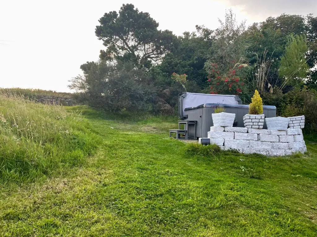 a pile of bricks in a field next to a truck at Ceol na Mara in Berriedale