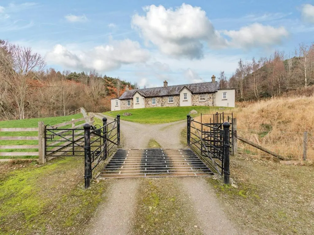 an old house on a hill with a gate in front at Allt Bronach - Ukc5763 in Laggan