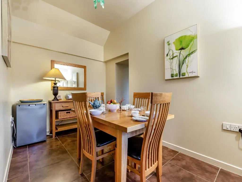 a dining room with a wooden table and chairs at Allt Na Criche - Ukc5762 in Laggan