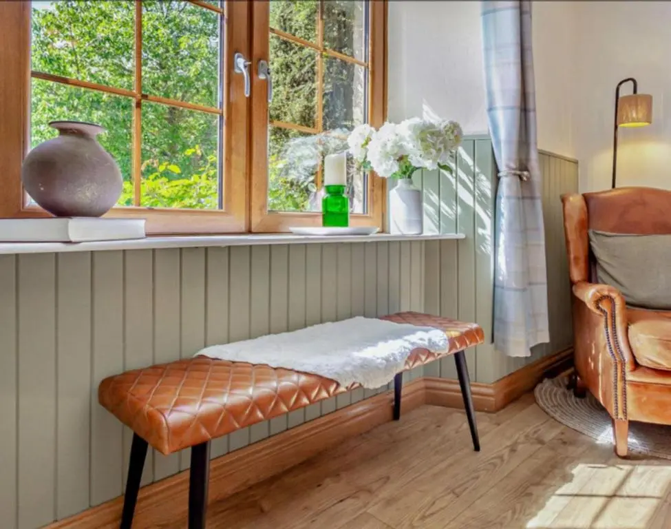 a bench in a room with a window and a chair at Rosemount Cottage TWO - Highland Cottage in Garve