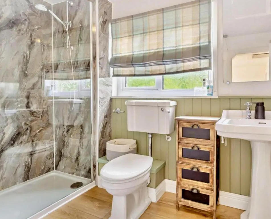 a bathroom with a toilet and a shower and a sink at Rosemount Cottage TWO - Highland Cottage in Garve