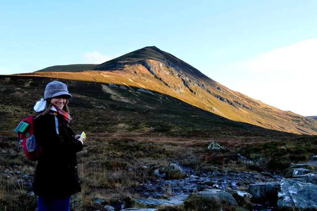 a woman standing in front of a mountain at Rosemount Cottage TWO - Highland Cottage in Garve