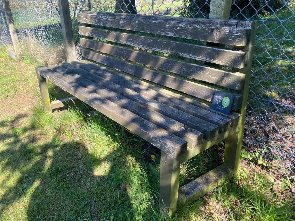 a wooden bench sitting in front of a fence at Drummond Neuk - Pets Welcome free, country setting, free onsite parking in Inverness