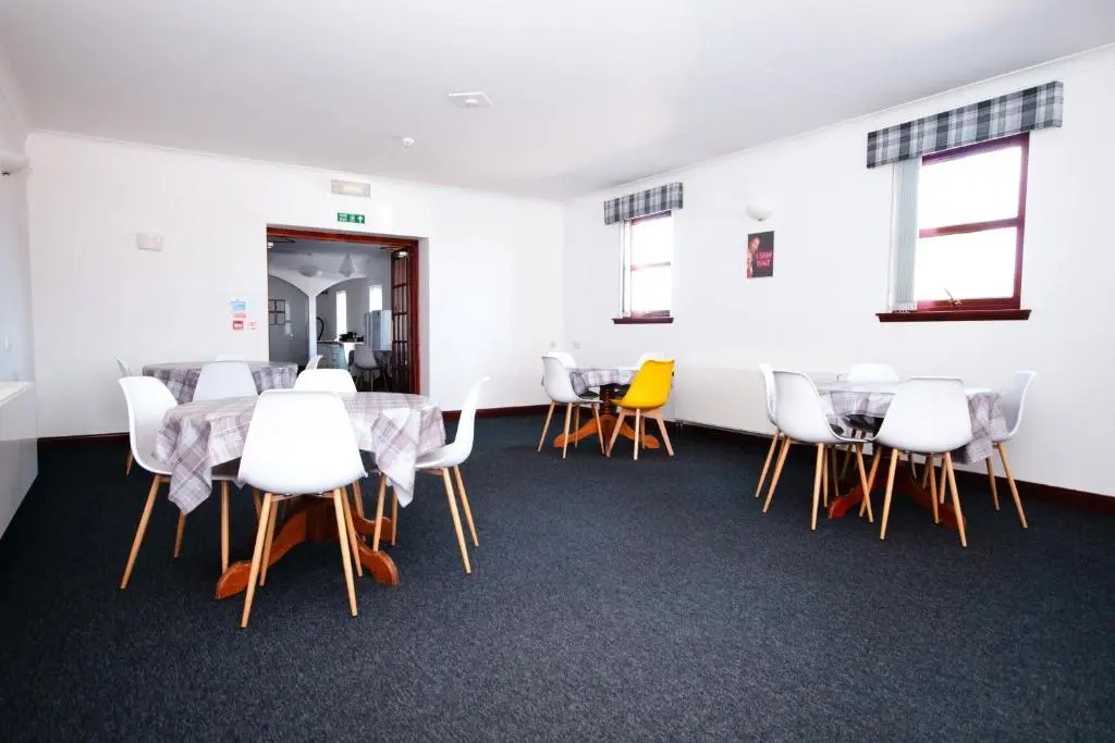 a conference room with a table and chairs at Weston House Keith in Keith