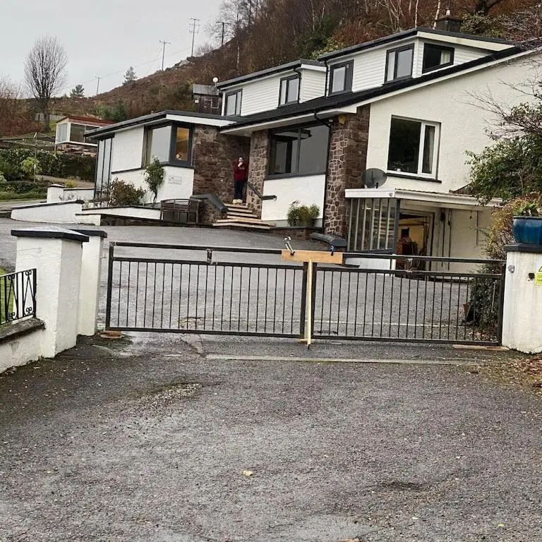 a house with a fence in front of it at Foinaven House in Ullapool
