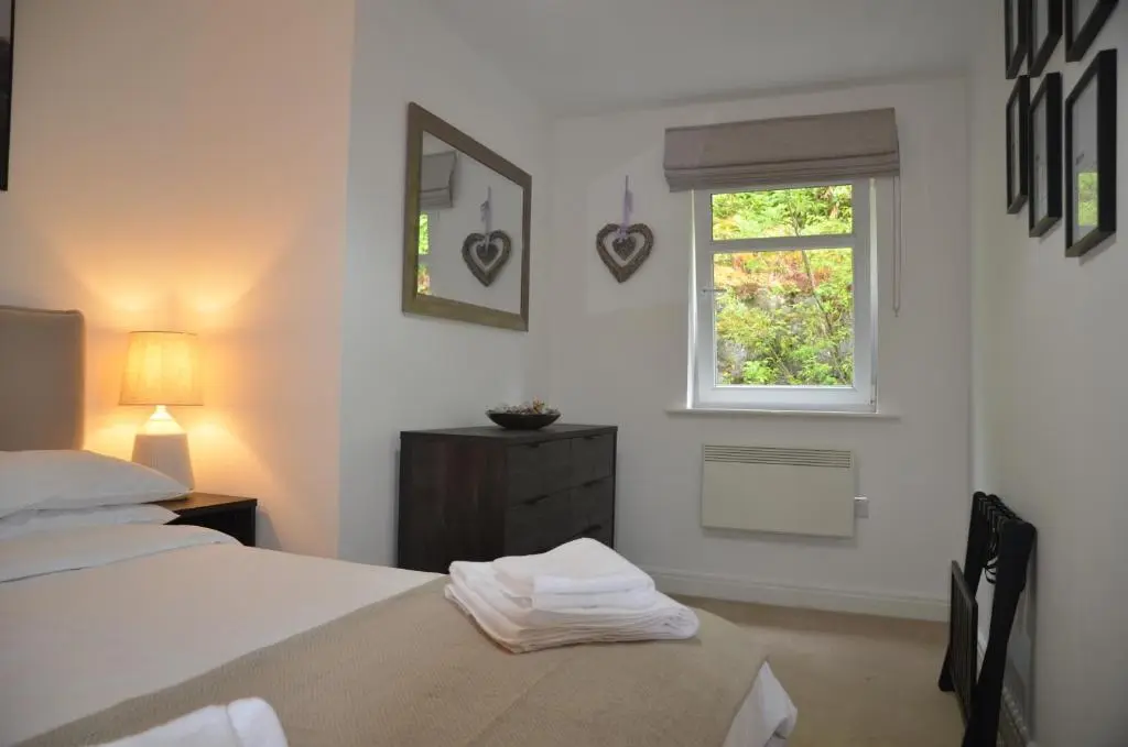 a bedroom with two beds and a window at SCOTTISH HIGHLANDS Superb 2 bedroom apartment. in Invergarry