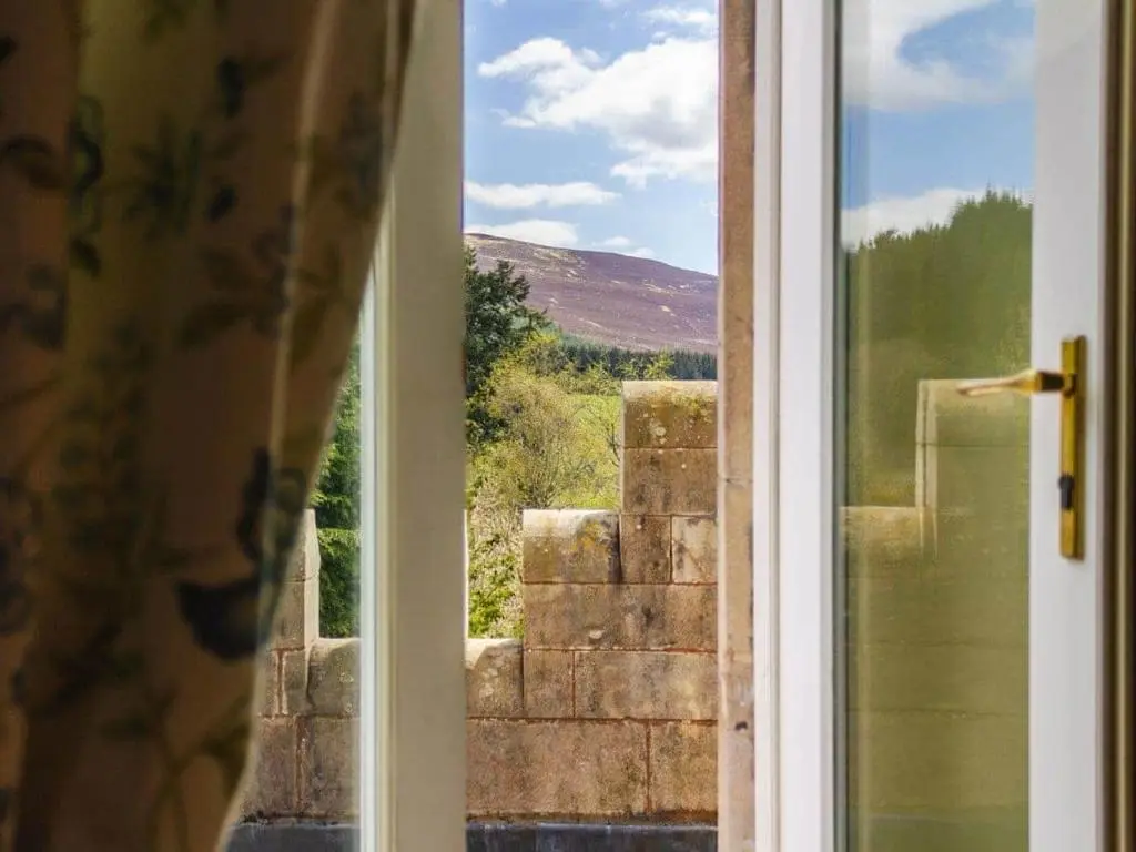an open door with a view of a window at Dalnaglar Castle in Blairgowrie