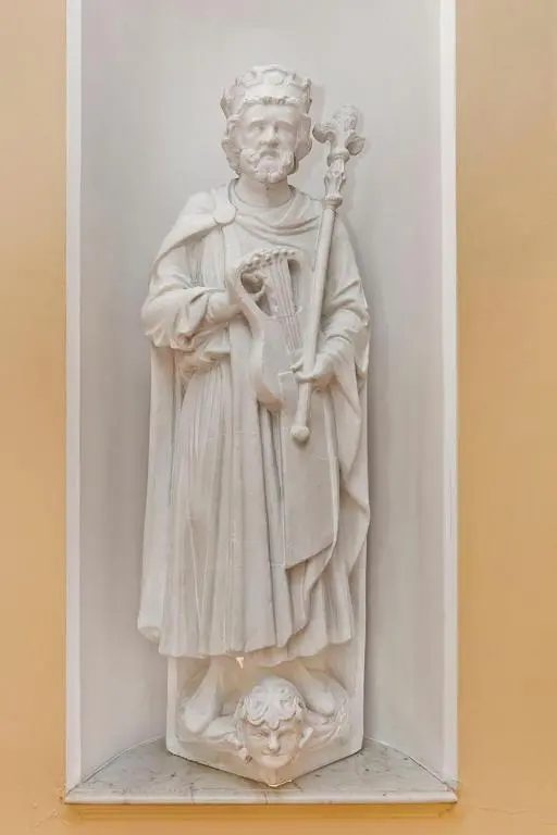 a white statue of a man holding a instrument at Dalnaglar Castle in Blairgowrie