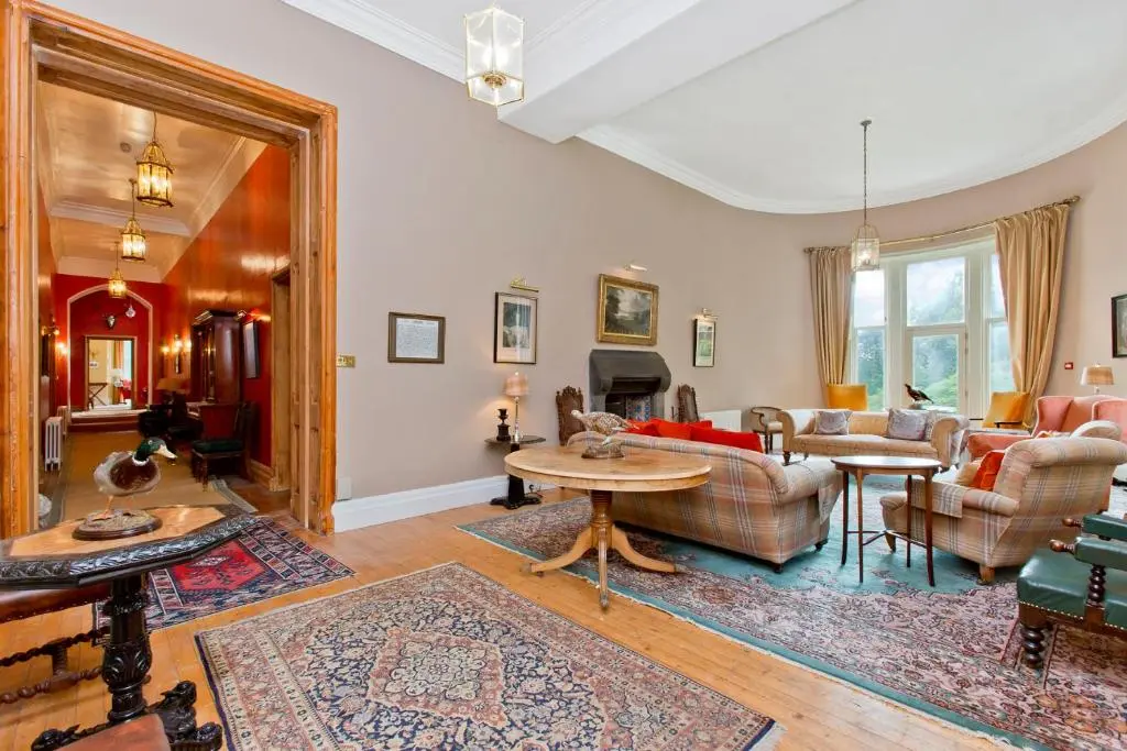 a living room with a couch and a table at Dalnaglar Castle in Blairgowrie
