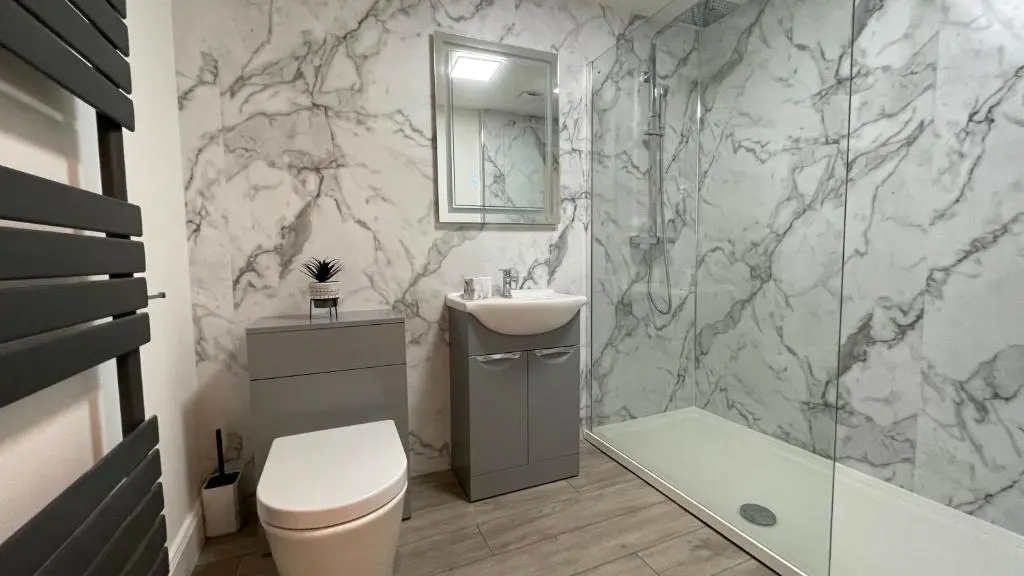 a bathroom with a toilet and a sink and a shower at The Forge by Caithness Luxury Apartments NC500 - Elegant Luxury Apartment with Bike store - Sleeps 4 in Wick