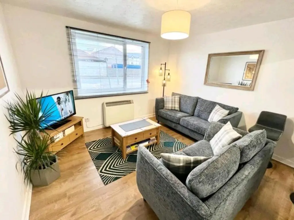 a living room with a couch and a tv at Two Bed Holiday Home with Free Parking in Inverness in Inverness