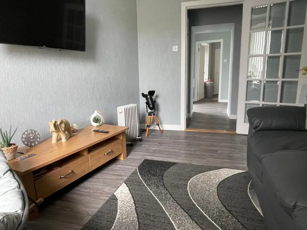a living room with a couch and a tv at Helens Lybster cosy cottage on NC500 in Lybster