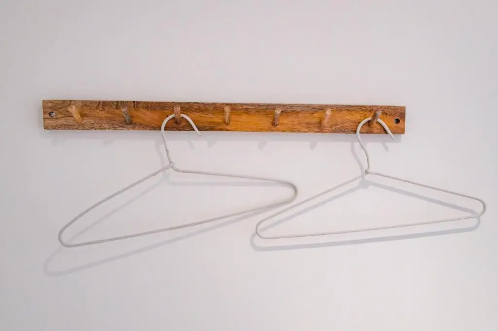 a pair of hanging lights hanging from a wooden beam at Anne's Place in Boat of Garten