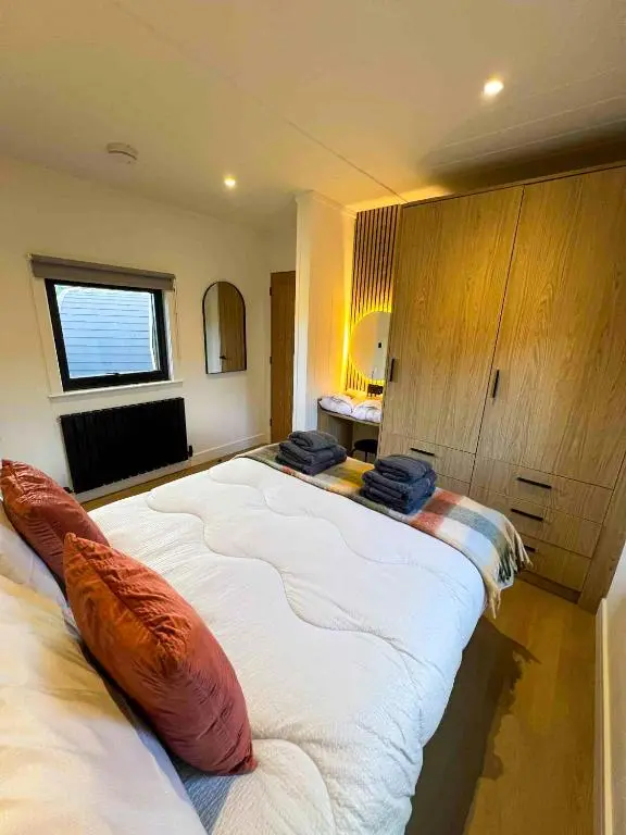 a bedroom with a large bed with pillows on it at Newmore Highland Pods with Hot Tubs on NC500 in Invergordon