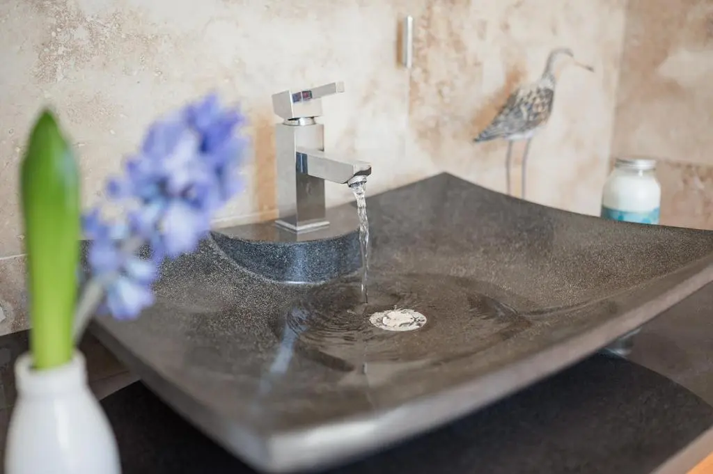 a bathroom sink with water running from a faucet at Strathallan Bed and Breakfast in Grantown on Spey