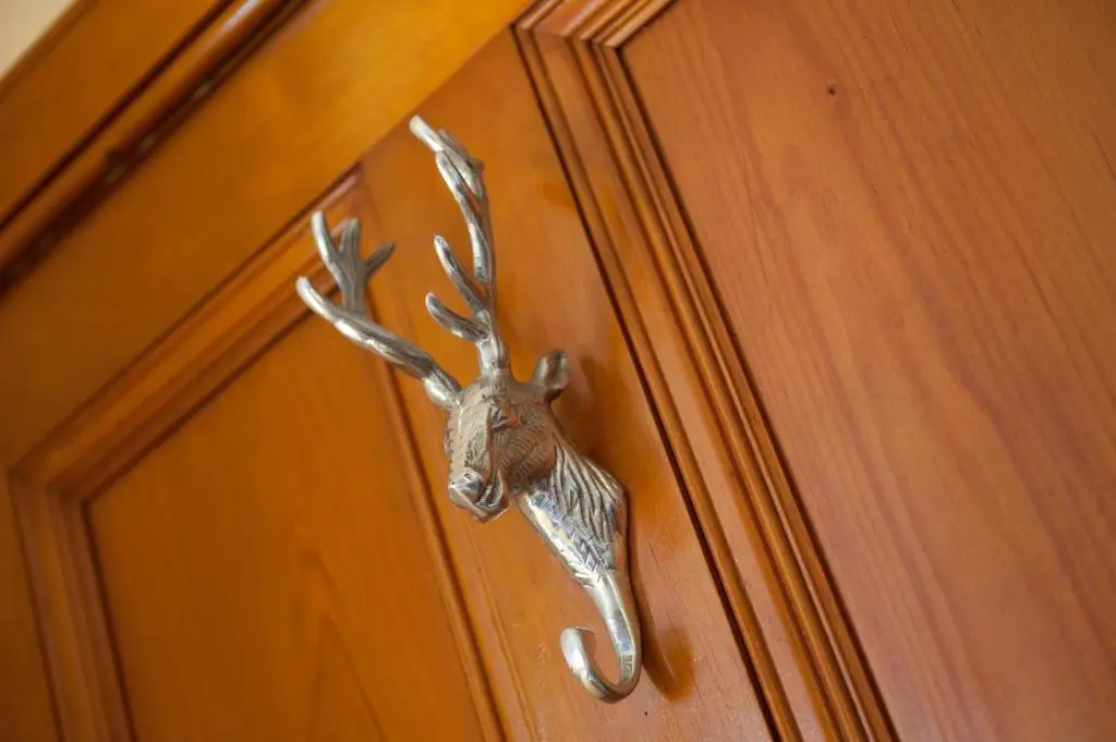 a deer head door knocker on a wooden door at Strathallan Bed and Breakfast in Grantown on Spey
