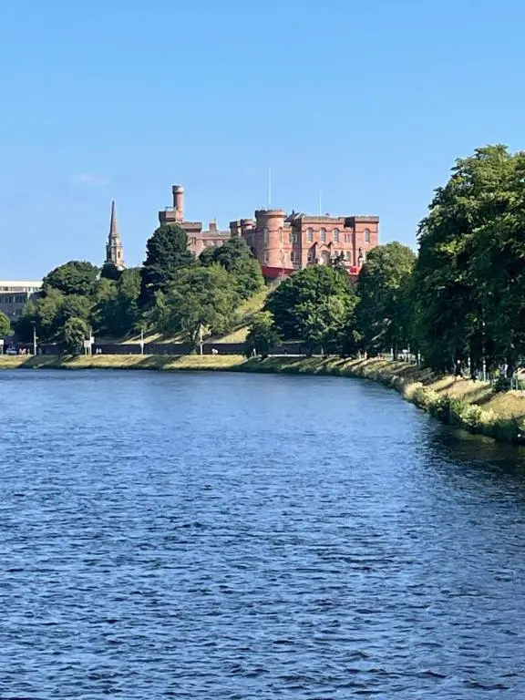 a view of a river with a city in the background at Haugh Ness in Inverness