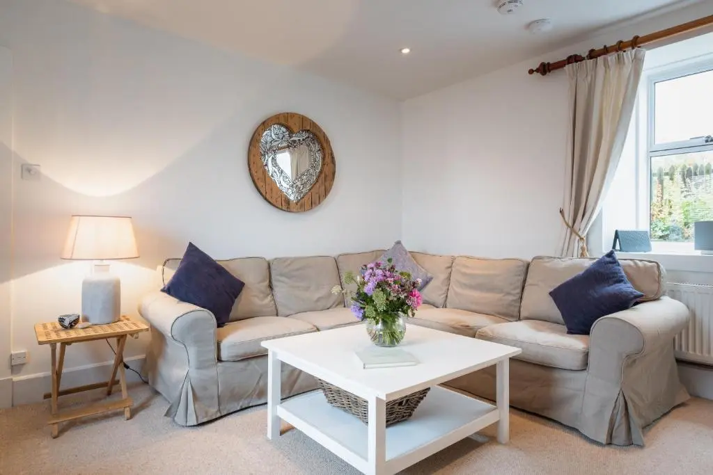 a living room with a couch and a table at Seaside cottage on Moray coast in Portknockie