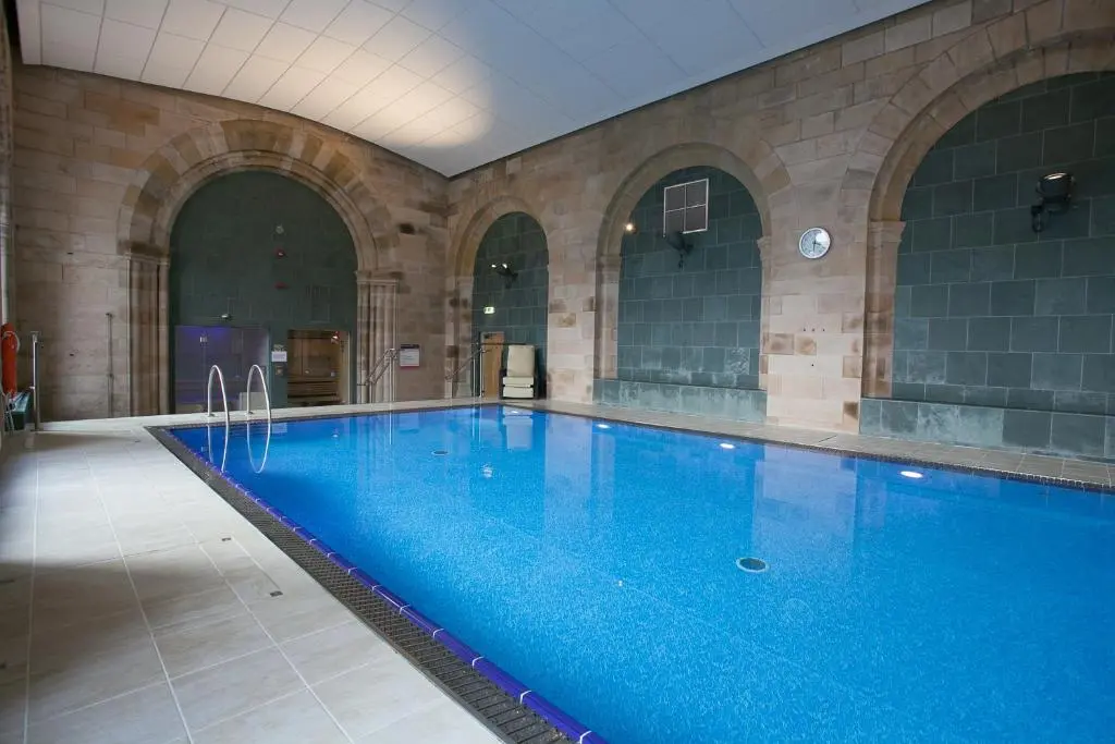 a large swimming pool in a large building at Raven Wing Apartments - Highland Club Scotland in Fort Augustus