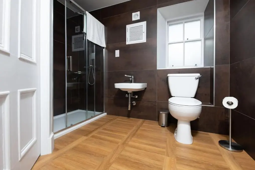 a bathroom with a toilet and a sink and a shower at Lock Keepers Cottage, Loch Ness Cottage Collection in Inverness