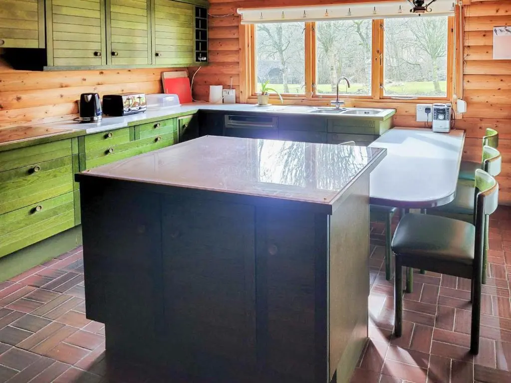 a kitchen with a large island in the middle of it at Ardle Lodge in Enochdhu