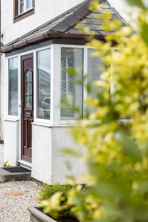 a house with a brown door and windows at Apartment No16 in Inverness