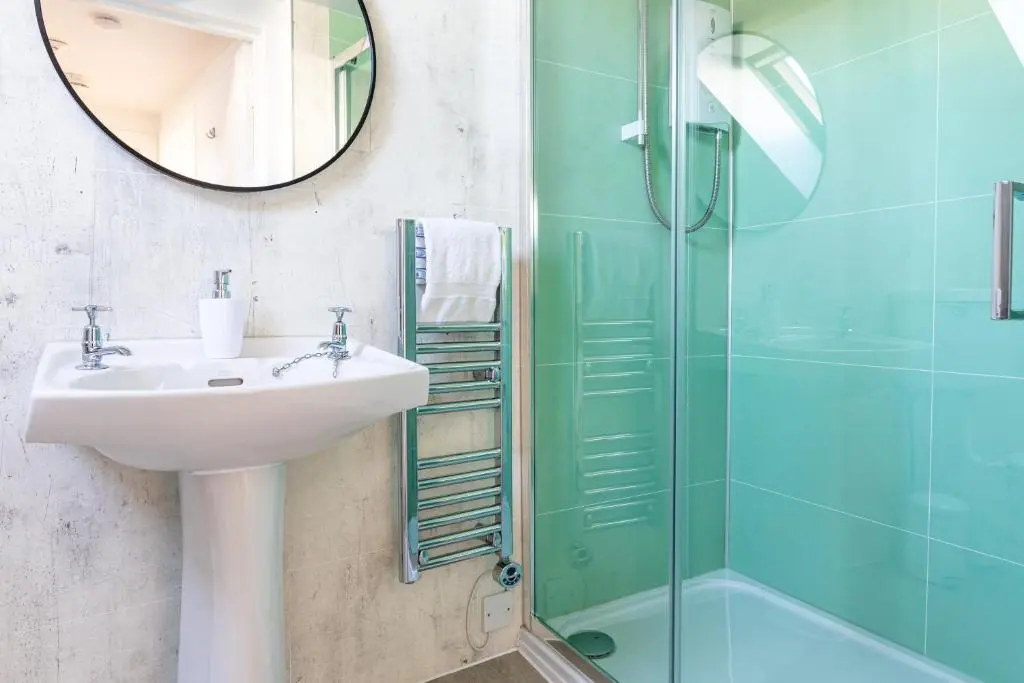 a bathroom with a sink and a shower at Thistle do Nessly in Inverness