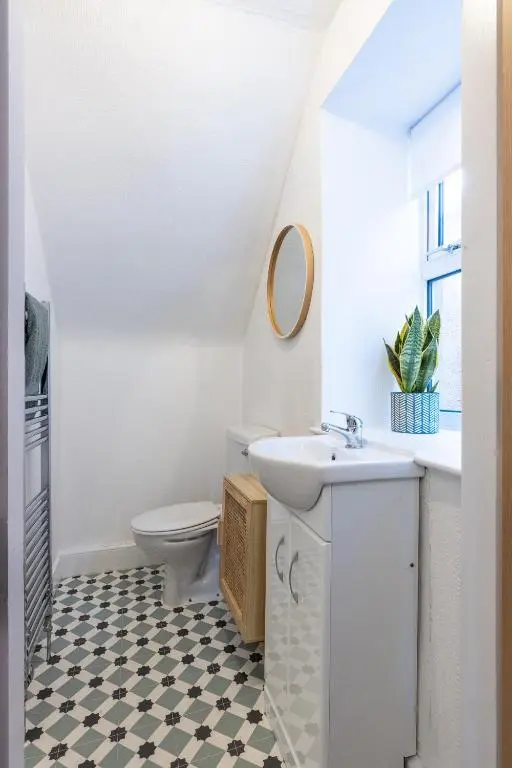 a bathroom with a sink and a toilet at Hill Street Haven in Inverness