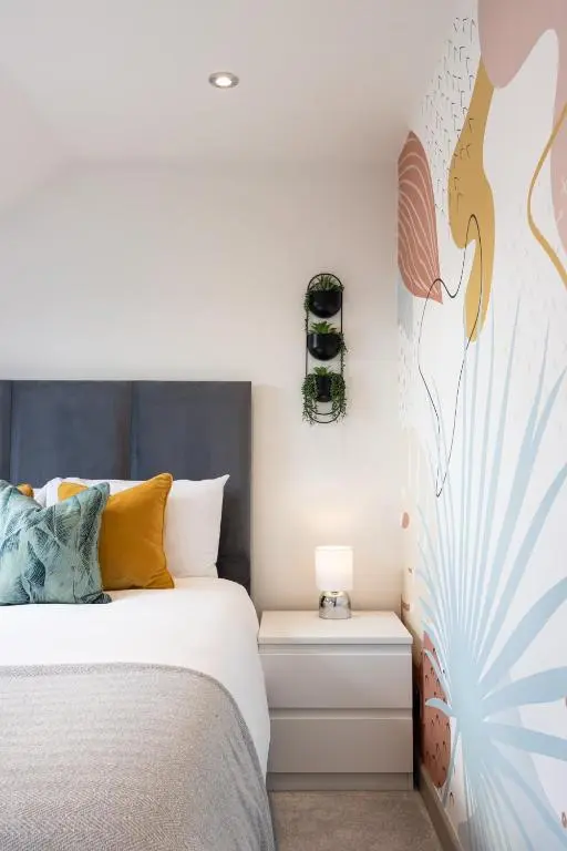 a bedroom with a bed and a wall with a bird mural at Fern View in Inverness