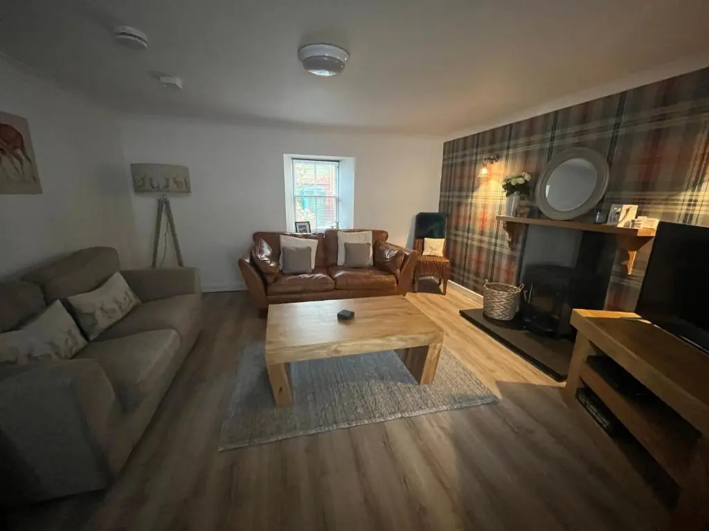 a living room with a couch and a coffee table at North Coast Property - 17 Margaret Street - Avoch in Avoch