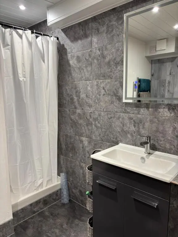 a bathroom with a sink and a shower curtain at Ardenbeg in Grantown on Spey