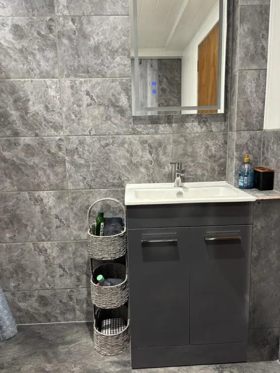 a bathroom with a sink and a counter with baskets at Ardenbeg in Grantown on Spey