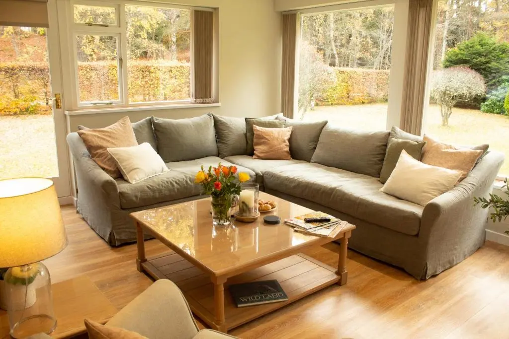 a living room with a couch and a coffee table at Dalnaglar in Nethy Bridge