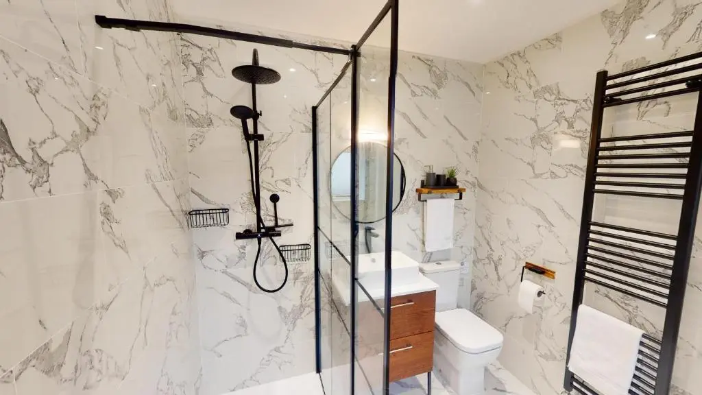 a bathroom with a shower and a toilet and a sink at Dalnaglar in Nethy Bridge