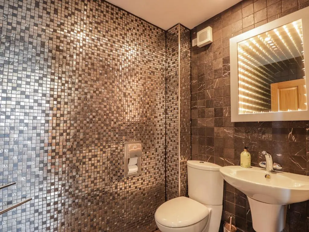 a bathroom with a toilet and a sink and a shower at Lossiemouth Bay Cottage in Lossiemouth