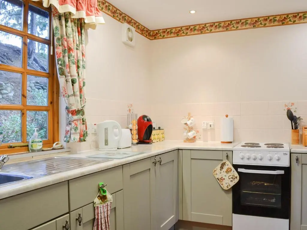 a kitchen with a sink and a stove at Toll Bridge Lodge in Banchory