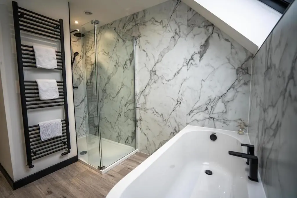 a bathroom with a shower and a white bath tub at FAMILY FRIENDLY, HOT TUB, Fire Pit, Spacious & Modern in Fochabers