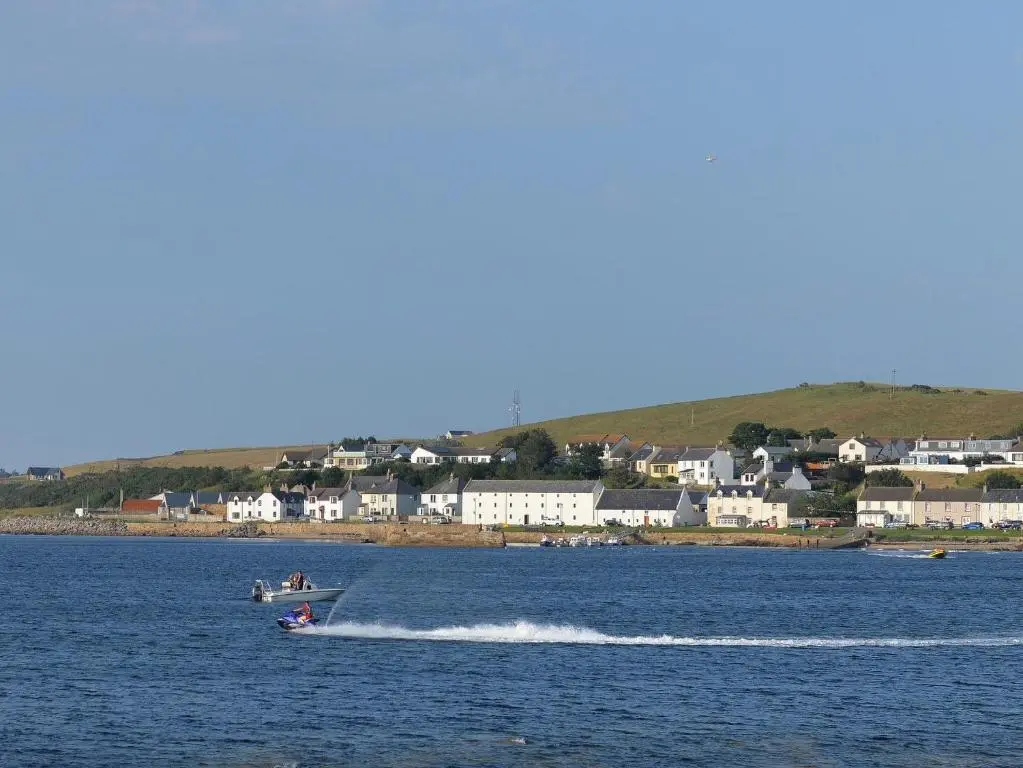 a group of people on a boat in the water at Well Cottages in Portmahomack