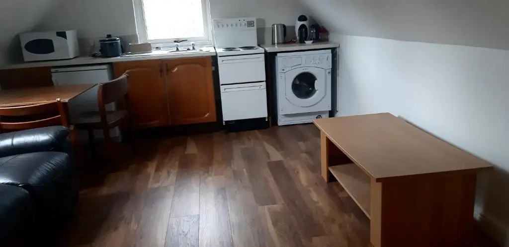 a kitchen with a stove and a washer and dryer at 1 Bed Flat - Sleeps 4 - Garden - Parking - Wifi in Inverness