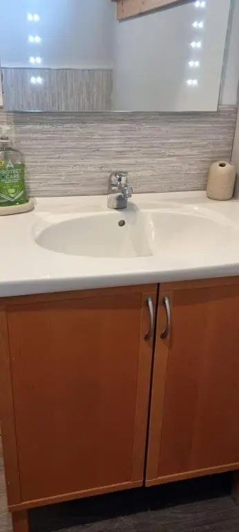 a bathroom sink with a white counter top at The Shelter Stone Cottage in Aviemore