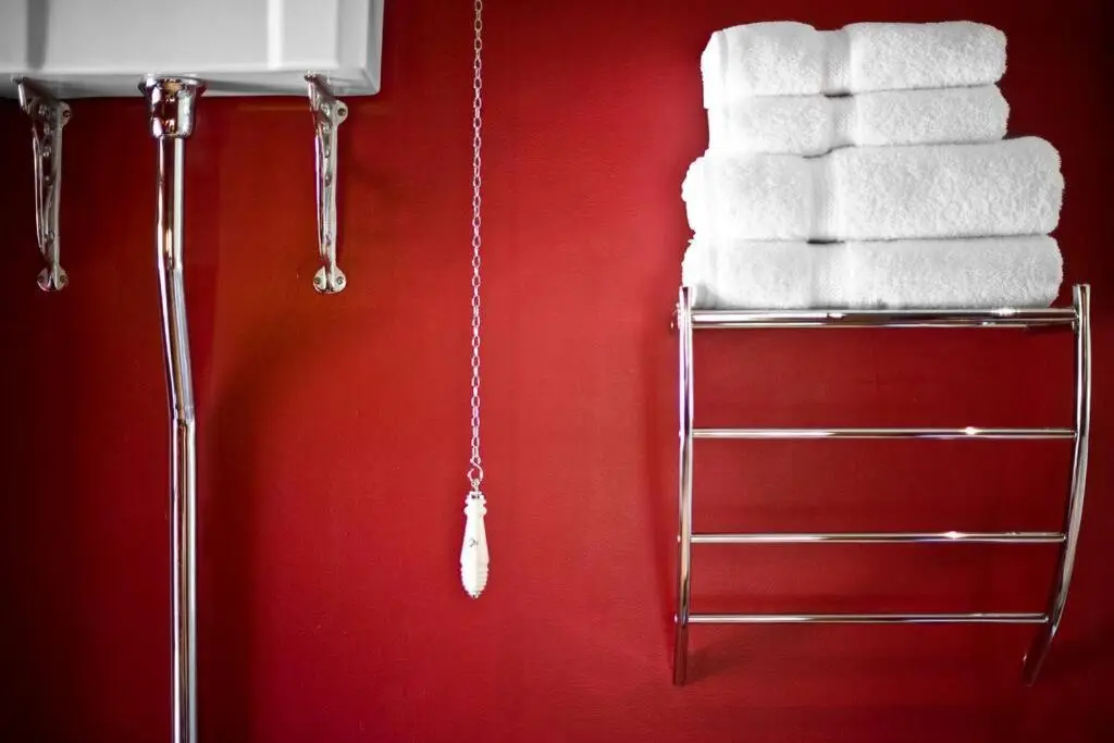 a stack of towels on a rack in a bathroom at Assynt House - Exclusive Use Holiday House in Dingwall