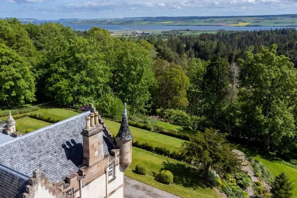 an aerial view of an old castle with a garden at Assynt House - Exclusive Use Holiday House in Dingwall