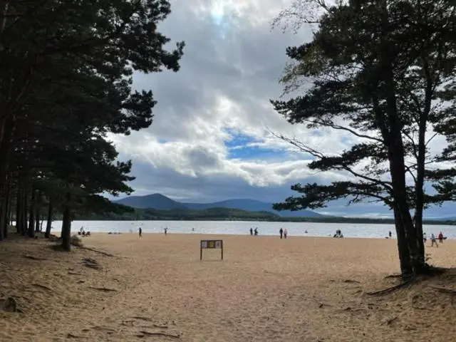 a beach with people and a goal in the sand at Stag's Hide in Aviemore