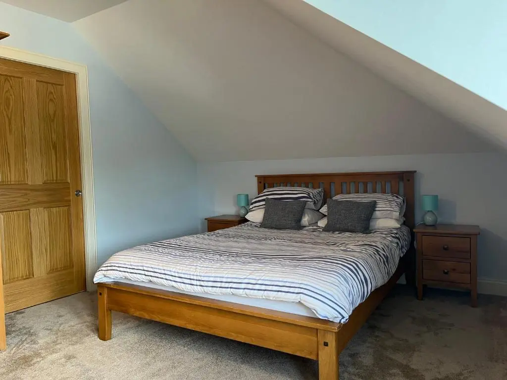 a bedroom with a bed with two pillows on it at Corsee House in Nairn