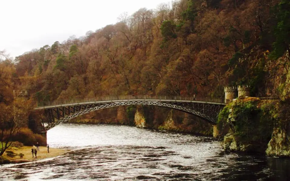 a bridge over a river next to a mountain at Ben View Aberlour Luxury Barn Conversion in Aberlour